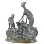 A 20th century bronze figure of of two goats on a rocky outcrop, after Moigniez,