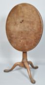 A George III mahogany tilt top table on turned pedestal, on three cabriole legs,