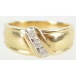 A yellow metal ring. Set with three round brilliant cut diamonds stated to weigh a total of 0.25cts.