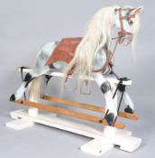 A 20th century carved wood and painted rocking horse with white horse hair mane and tail,