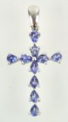 A white metal cross pendant set with ten pear faceted cut tanzanite.