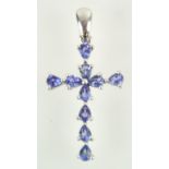 A white metal cross pendant set with ten pear faceted cut tanzanite.