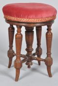 A late 19th Century Victorian antique mahogany piano stool having raising twist mechanism,