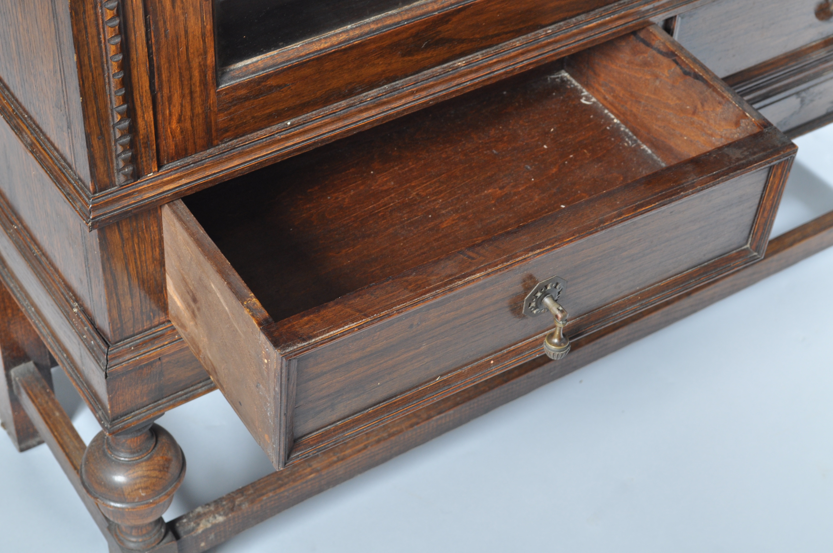 An oak display cabinet with two glazed doors above two frieze drawers on baluster turned legs, - Image 3 of 4