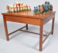 A 20th Century retro vintage wooden gaming table having a two tone chequer board top