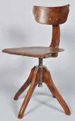 An early to mid 20th century engineers/architects swivel chair having a shaped adjustable backrest,