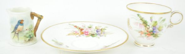 A Royal Worcester cabinet cup and saucer, decorated with floral sprays and a monogram,