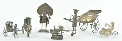 A group of Asian white metal model rickshaws, the largest 9cm high,