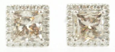 A white metal pair of cluster stud earrings.