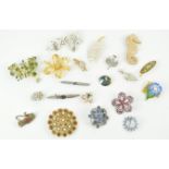 A collection of twenty costume jewellery brooches, of varying designs,