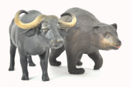 A Coalport bisque figure of a water buffalo, 21cm wide and a Coalport figure of a bear,