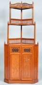 A contemporary Chinese rosewood corner cabinet having a two tier shelved top with pierced galleries