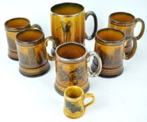 An Arthur Wood pottery sports series mug, printed with golfing figures, 13cm high,