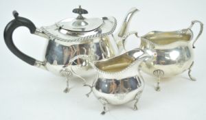 A silver three piece tea service, of shaped oval form,