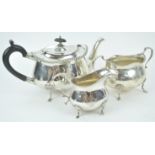 A silver three piece tea service, of shaped oval form,