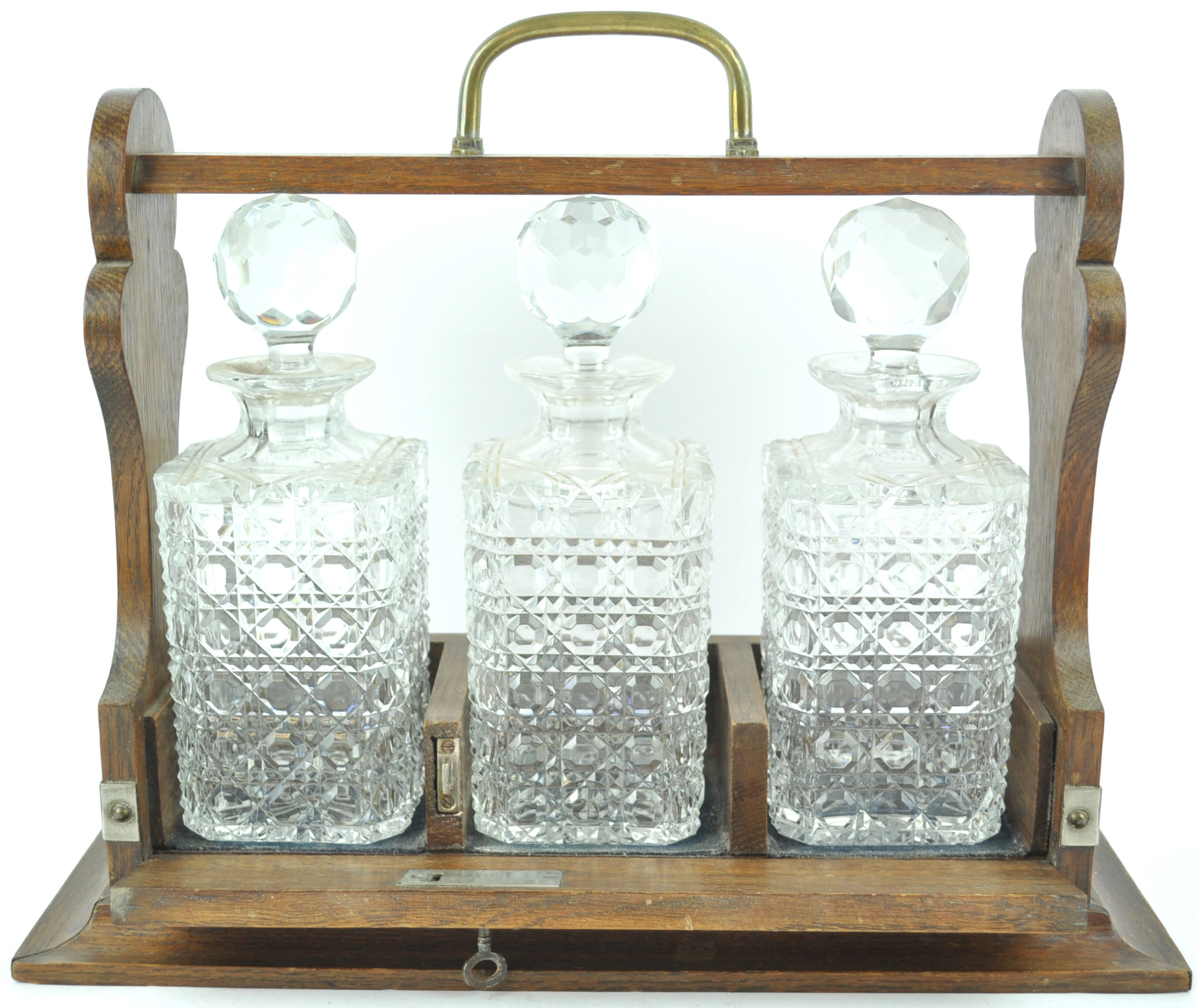 An oak framed tantalus, with brass handle, enclosing three square cut decanters and stoppers, - Image 3 of 3