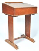 An early 20th century antique vintage oak single school desk having a hinged top revealing a