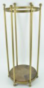 A brass tubular umbrella stand with ball finials ad feet 66cm high x 26cm diameter