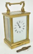 A brass carriage clock with rectangular enamel dial