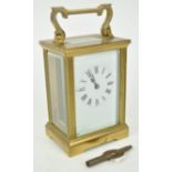 A brass carriage clock with rectangular enamel dial