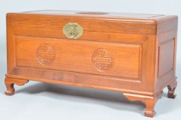 A contemporary Chinese camphorwood /camphor wood coffer / trunk having a carved symbol to the lid