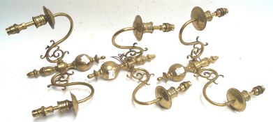 A set of three brass wall lights