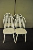 A set of four white painted stick back chairs with later seats