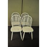 A set of four white painted stick back chairs with later seats