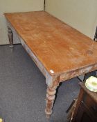 A rectangular pine table on turned legs