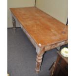 A rectangular pine table on turned legs