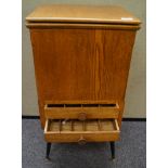 An oak sewing box with drawers