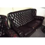 A leather button back three seat sofa