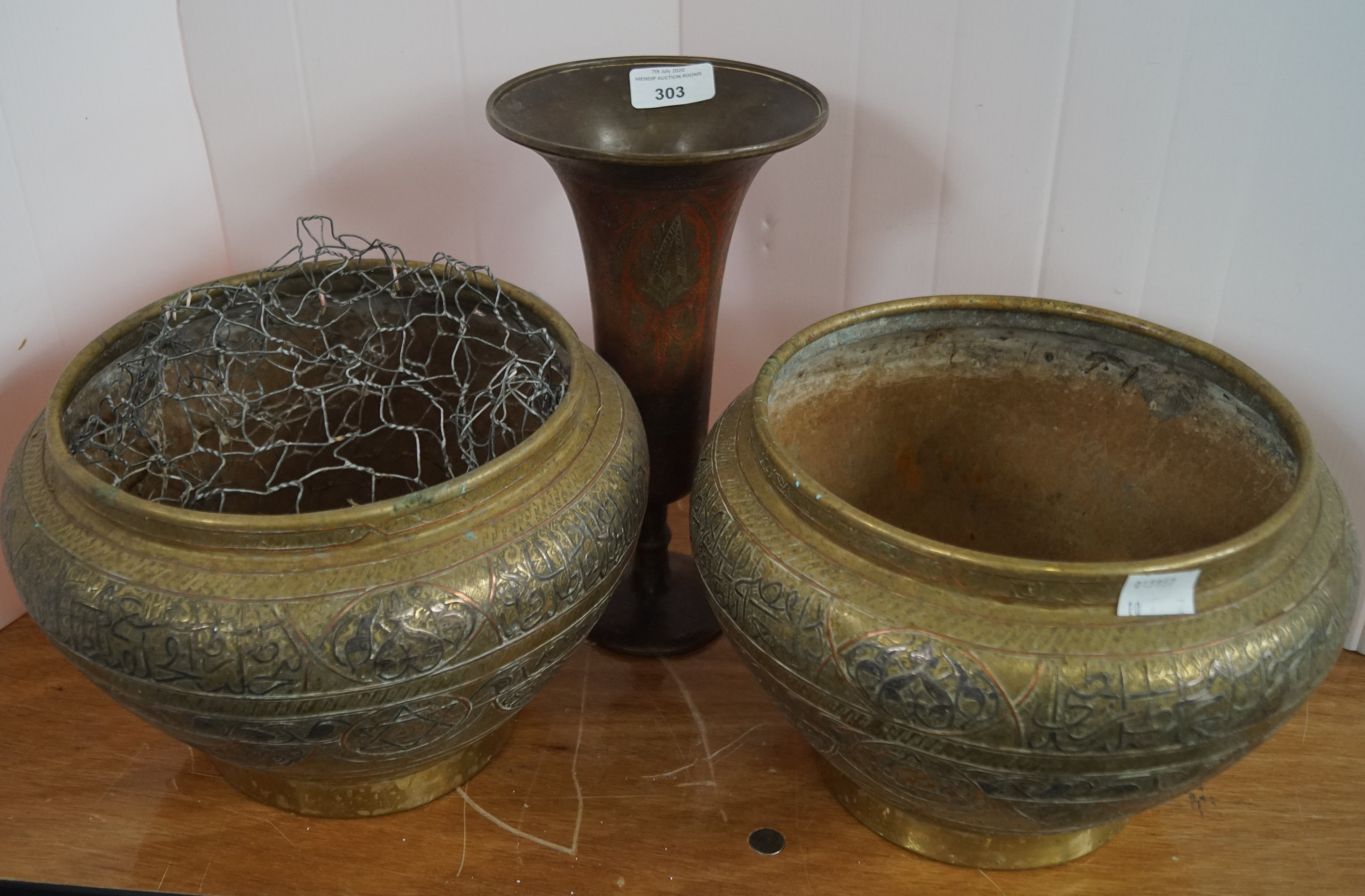 A pair of brass silver and copper inlaid jardinieres and a vase