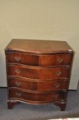 A mahogany serpentine chest