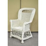 A painted white wicker chair