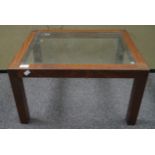 A glass topped oak coffee table