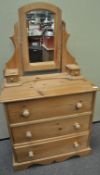 A pine chest of drawers and a mirror