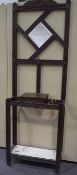 An antique oak carved hall stand with mirror top and drip tray to base,