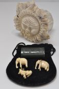 A reindeer antler carving, two early 20th century elephant charms,