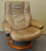 An Ekorns stress-less chair in caramel leather on a wood base