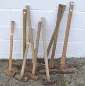 A collection of tools comprising four sledge hammers and five picks