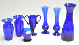 A group of assorted blue glass items