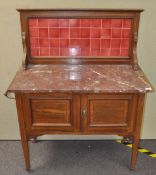 An early 20th century mahogany wash stand with marble top and tiled gallery,