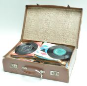 A vintage composite suitcase containing records