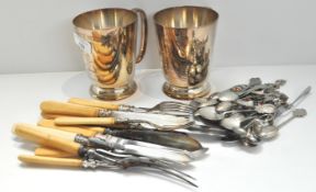 A fish set and some spoons (including some silver) and two plated mugs