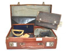 A vintage suitcase containing drawing and draughtsman's sets