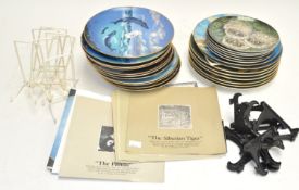 A collection of wildlife plates with certifcates
