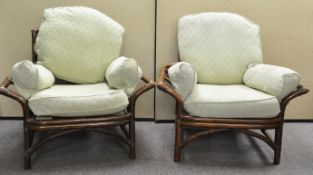 Two rattan armchairs with cushions
