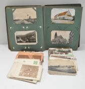 Over 200 early 1900's postcards in album,