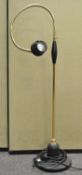 A contemporary goose neck brass and black standard lamp/reading lamp,